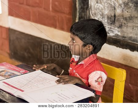 Puduchery, India - December Circa, 2018. Unidentified Cute Beautiful Poor Concentrated Kid Reading A
