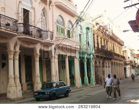 Havana, Cuba - June 21, 2018: Cuban Men Taking A Walk Across The Streets Of Havana Near The Colorful