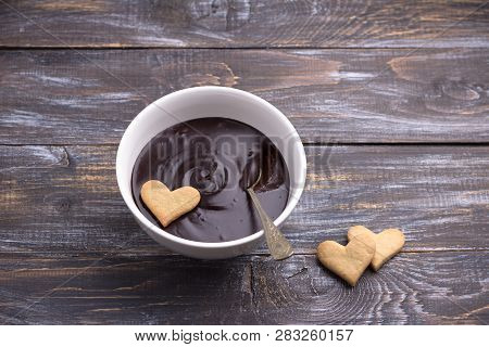 Bowl Of Delicious Chocolate Mousse And Heart Cookies For Valentine's Day On Wooden Background
