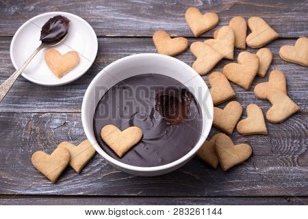 Bowl Of Delicious Chocolate Mousse And Heart Cookies For Valentine's Day On Wooden Background