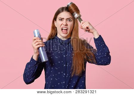 Horizontal View Of Dissatisfied Woman Combes Hair, Arent Satisfied With New Shampoo Or Hair Product,