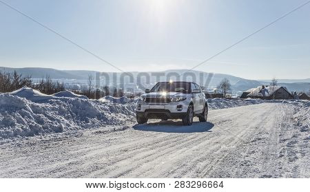White Range Rover Evoque With A Black Roof On A Winter Road On The Background Of Zhiguli Mountains O