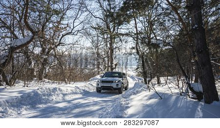 White Range Rover Evoque With A Black Roof On A Winter Road In The Forest Of The Samara Region, Russ