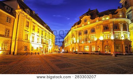 Night Scene Of Piata Mare Central Square In Historical Sibiu.  Cityscape Of Sibiu Town, Transylvania
