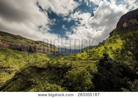 Cliffs And Hillsides Under A Dramatic Sky, Along The Tugela Gorge Hiking Route At The Base Of The Am