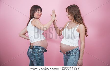 Maternity Concept, Two Pregnant Women With An Open Tummy