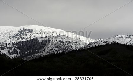 Mountains And Forest With Snow On The Background Of Clouds On A Sunny Day On The Island Of Evia (eub