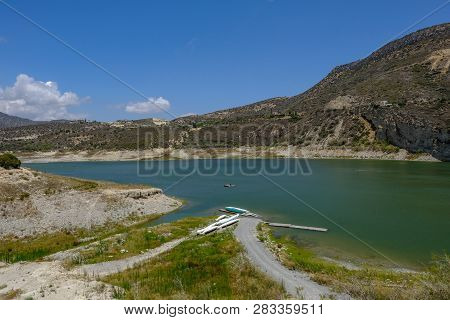 Scenic Landscape Shot Of Germasogeia Dam In Cyprus On A Beautiful Blue Sky Day.  Shot Shows Path Dow