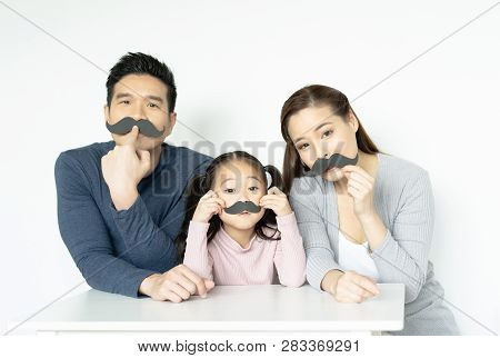 Asian Family With Fake Mustache. Happy Family Playing In Home. Family Holidays And Togetherness.