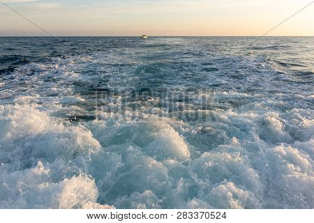 Powerful Waves And Foam Astern Of The Yacht When Moving During Sunset