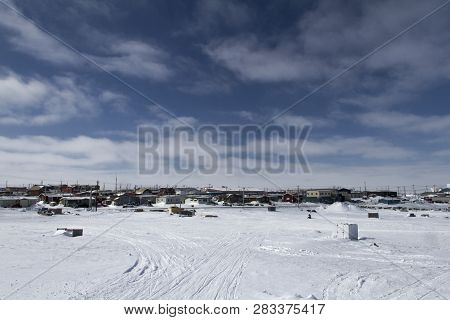 View Of Rankin Inlet, A Remote Arctic Community In Nunavut With Blue Skies And Snow On The Ground