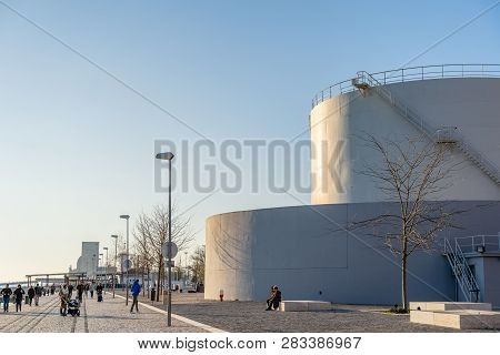 Lisbon, Portugal - 12/28/18: Pedestrian Walkway Riverside, Tagus River And Monument Of Discovery. Hu