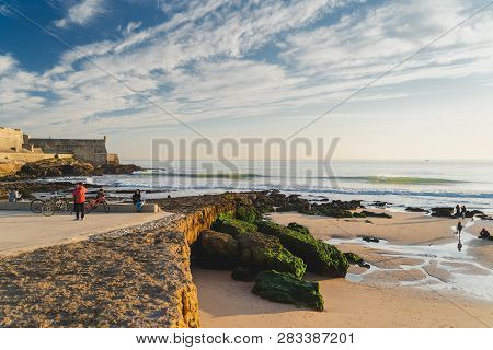 Carcavelos, Portugal - 12/31/18: Carcavelos Beach And Saint Julian Fortress. People Enjoying The War