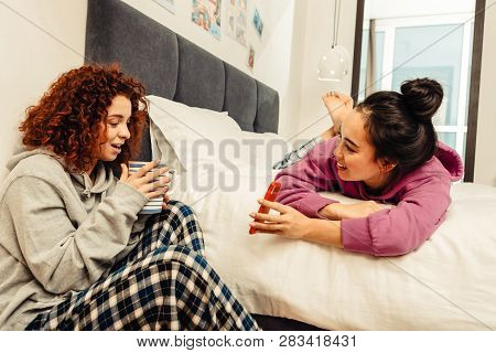 Dark-haired Friend Showing Photo Of Her Boyfriend To Her Friend