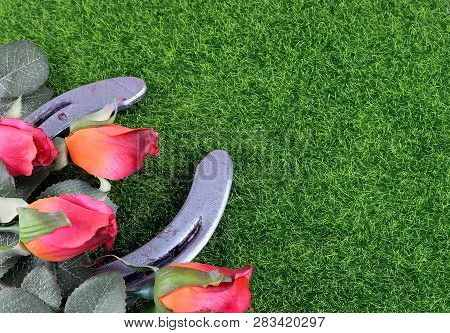 Red Silk Roses, A Horseshoe And Artificial Green Grass For The Running Of The Thoroughbred Race Call