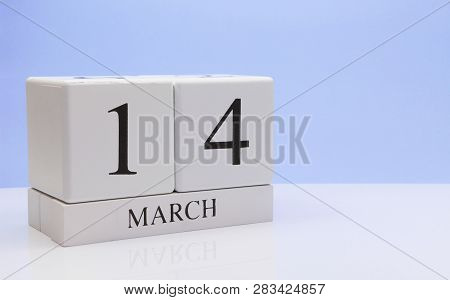 March 14st. Day 14 Of Month, Daily Calendar On White Table With Reflection, With Light Blue Backgrou