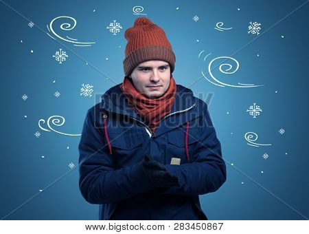 Young hipster frozen boy with doodled snowflakes and windy concept
