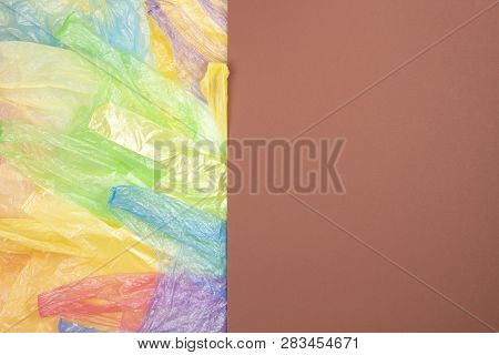 Multicolored Single Use Plastic Shopping Bags With Blank Brown Background For Text Or Image