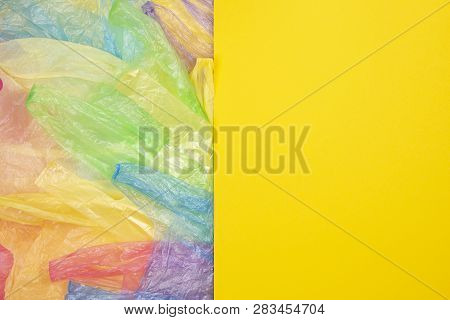 Multicolored Single Use Plastic Shopping Bags With Blank Yellow Background For Text Or Image