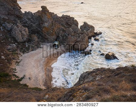 Wild Sea Bay With A Lonely Tent At Sunset