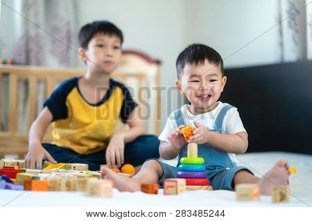 Brother And A Smile Boy Play A Toy Togather On The Bed, This Immage Can Use For Kid, Family, Educati