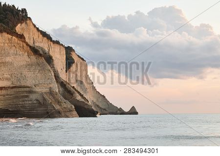 Beautiful Coastline With Cliffs In Corfu, Greece. Sunset View In Peroulades Region.