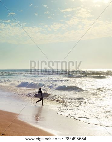 Surfer At The Atlanctic Ocean Beach. Algarve, Portugal