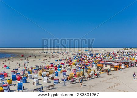 Borkum, Germany - July 25, 2018: Colorful Traditional Beach Chairs At The Boardwalk Of Borkum, Germa
