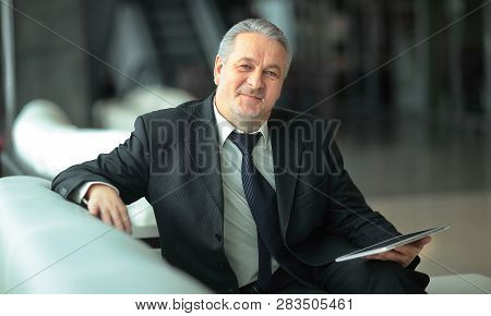 Serious Businessman Sitting In An Office Chair.people And Techn