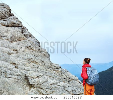 Wooman Hiker Is Standing Under The Cliff And Looking Up