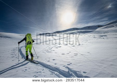 Mountaineer Skier Alone On A Marked Slope.