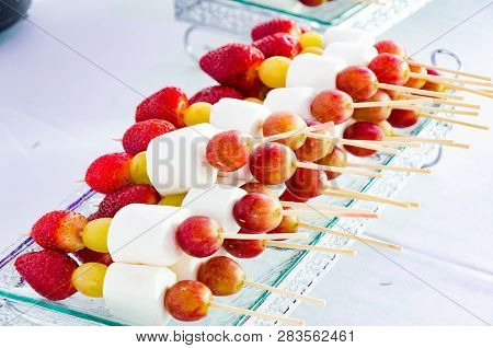 Skewers Of Strawberries, Marshmallows And Grapes Served In A Fountain, Concept Of Party Decoration O