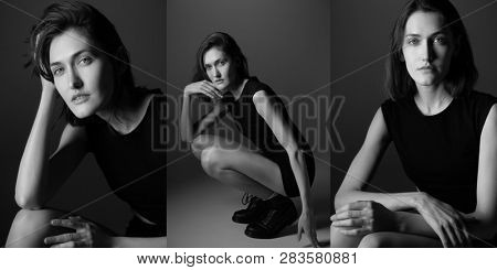 Fashion model. Young woman posing in studio wearing black drees and boots. Beautiful caucasian girl over gray background. black and white