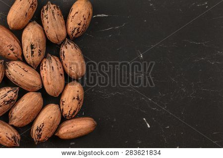 Tabletop View, Whole Pecan (carya Illinoinensis) Nuts With Spots On Shells (turkish Variety) On Blac