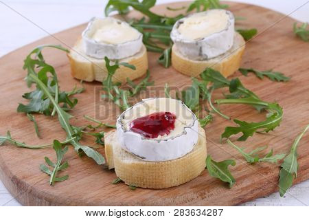 Cheese Saint-mor-de-touren With Raspberry Jam On White Wooden Background