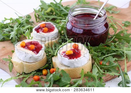 Cheese Saint-mor-de-touren With Raspberry Jam On White Wooden Background