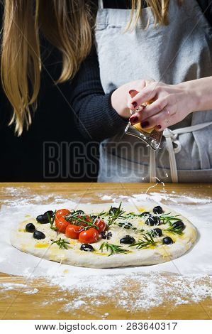 Cook Rubs Cheese On A Homemade Foccacia. Top View, Wooden Background