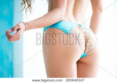 Close Up Half-turned Of Ideal Elastic Flawless Beautiful Womans Ass Wearing Blue Underlinen Underclo