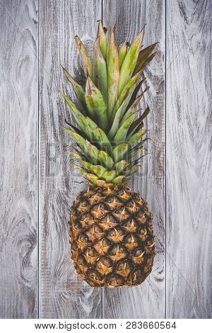 One Raw Pineaple On White Wooden Background Top View. Copyspace For Your Text, Banner.