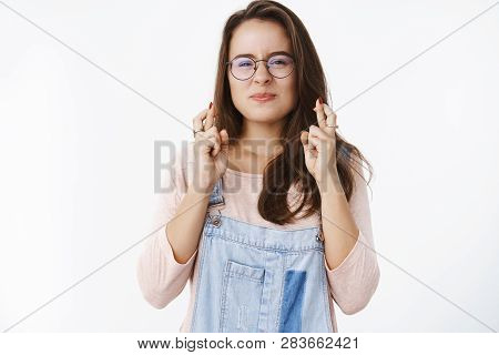 Waist-up Shot Of Hopeful Happy And Optimistic Cute Female In Glasses Squinting And Wrinkling Nose As