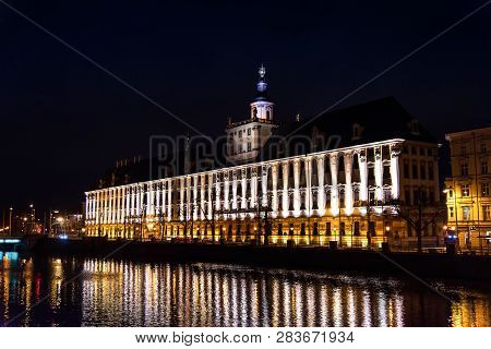 Wroclaw, Poland - December 23, 2018 - University Of Wroclaw Main Building By The River Odra Night Vi
