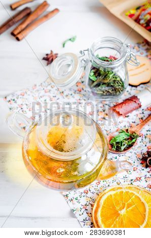 Tea Pot With Ho Greent Tea, Cup Of  Tea  With Mint,  Lemon Slice, Dry Fruits Roll And Tea Mint Leave