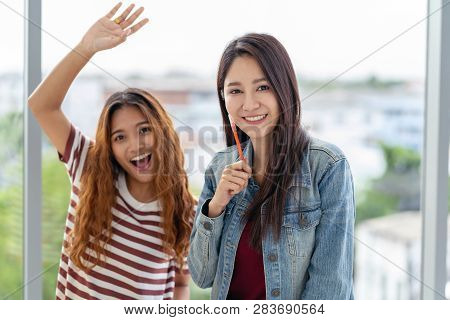 Portrait Of Asian Creative Woman With Colleagues In Happy Action When Working In The Modern Workplac
