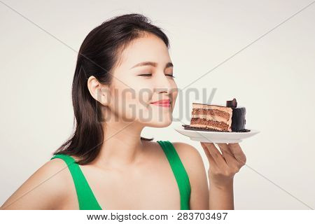 Beautiful Smiling Asian Young Woman With A Chocolate Cake Isolated On White Background.