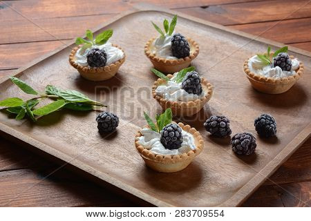 Delicious Tartlets On A Wooden Background. Blackberry With Cream - Dessert.healthy Homemade Berry De