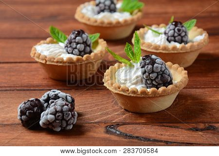 Delicious Tartlets On A Wooden Background. Blackberry With Cream - Dessert.healthy Homemade Berry De