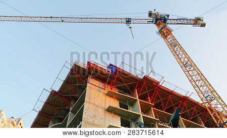 Crane. Construction Crane. Building Crane On The Background Of A Building.