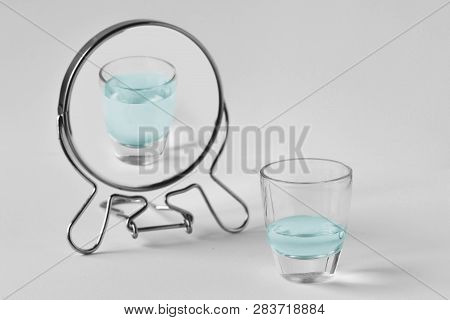 Half-empty Water Glass Looking In The Mirror And Seeing Himself As A Full Glass - Concept Of Optimis