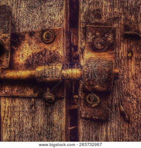Old Rusty Metal Lock On Outdoor Gate In Village Time-worn House