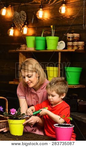 Transplanting Concept. Mother And Son Transplanting Flower In New Pot. Mother And Child Transplantin